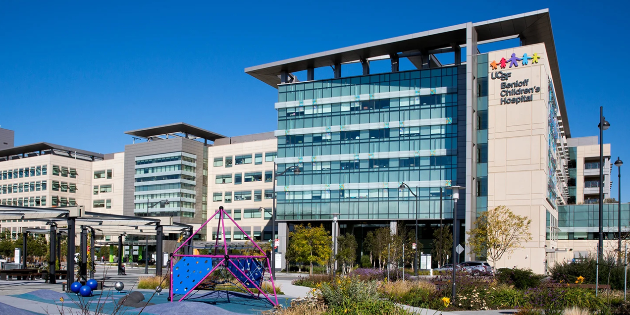 Exterior view of UCSF Benioff Children’s Hospital at the Mission Bay campus in San Francisco, showing the hospital building and surrounding outdoor space.