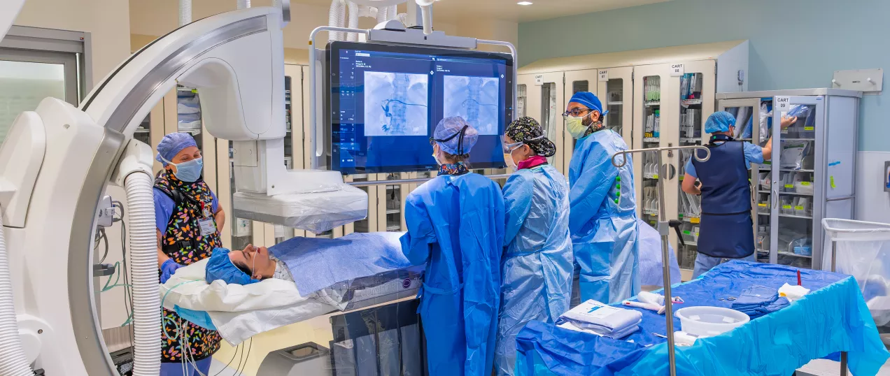 Doctors and nurses in Interventional Radiology suite