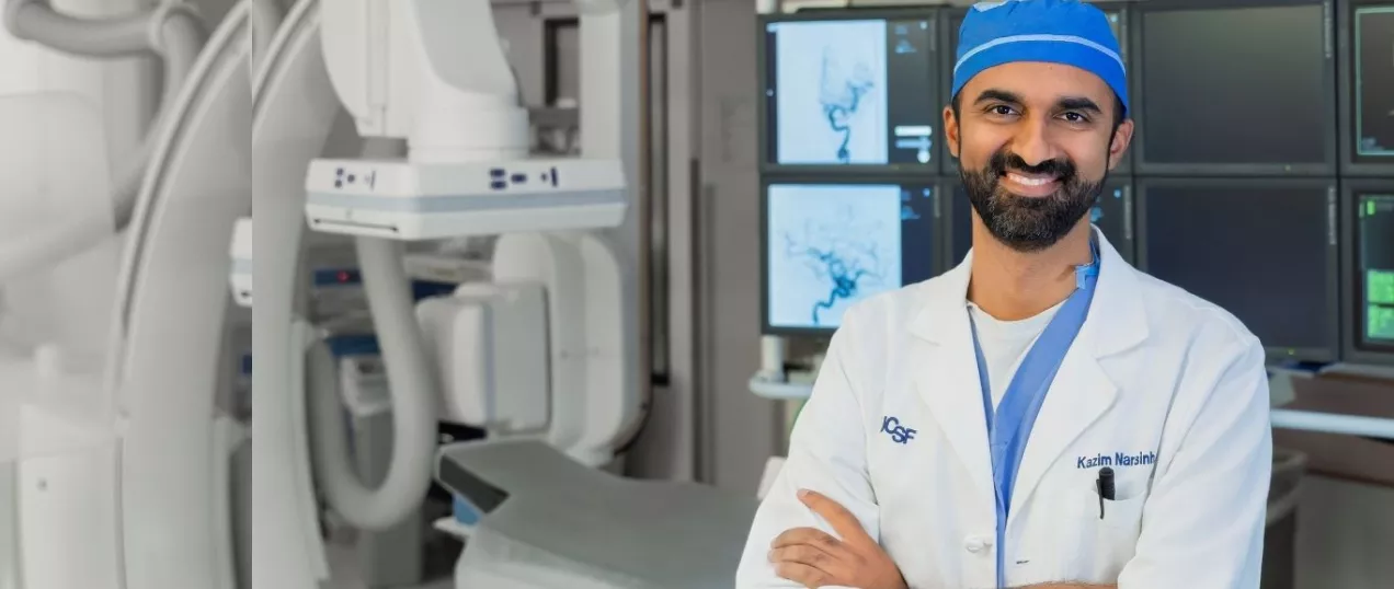 Radiologist smiling in neuroendovascular suite.
