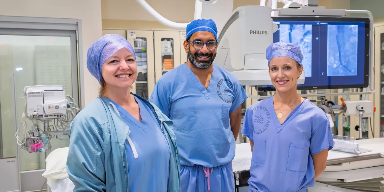Interventional radiologists smiling together in patient care room