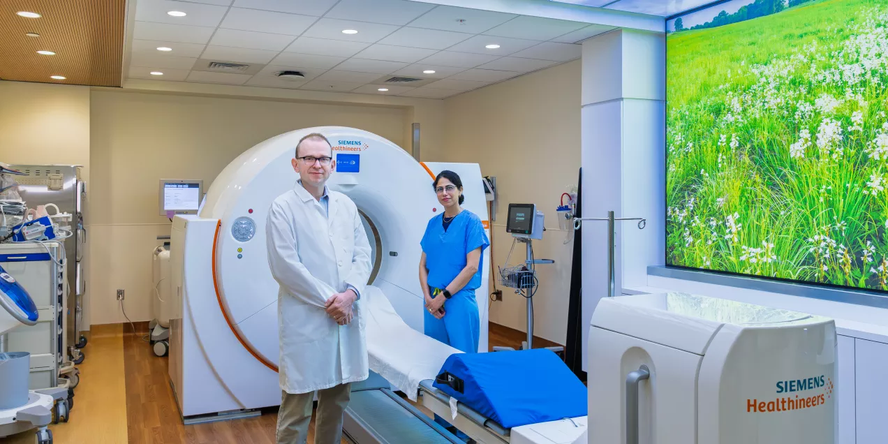 Radiologist standing in front of CT scanner