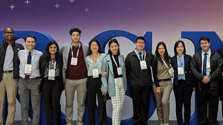 group of people standing next to one another