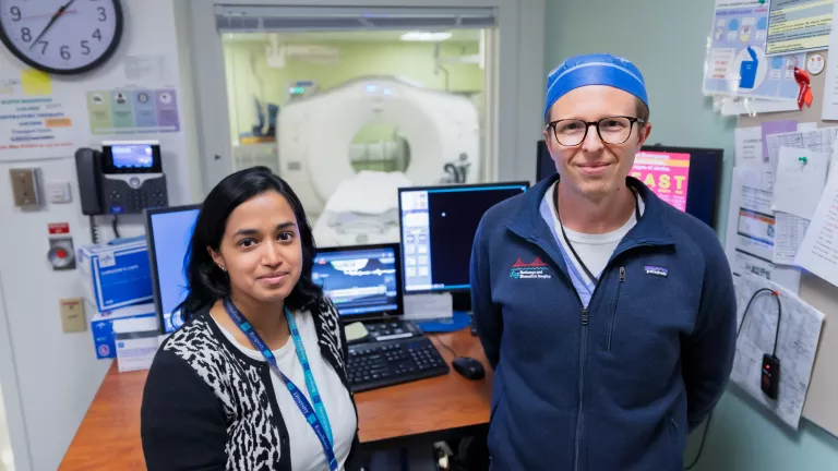 Neuroradiologists in front of scanner