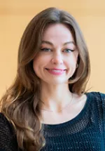 Professional headshot of a woman smiling, photographed indoors