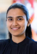 Professional headshot of a woman smiling, photographed indoors