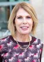 Professional headshot of a woman smiling, photographed outdoors