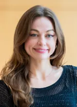 Professional headshot of a woman smiling, photographed indoors