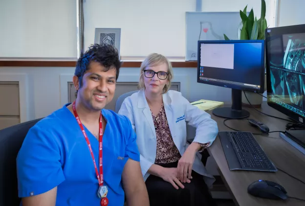 Faculty and trainee work together