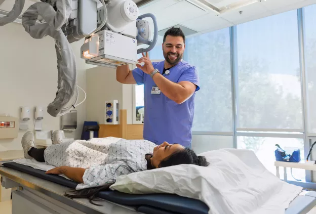 Patient and staff preparing for an imaging scan.