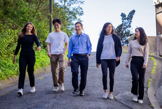 Lab team walking together in outdoor plaza at UCSF Parnassus Heights campus