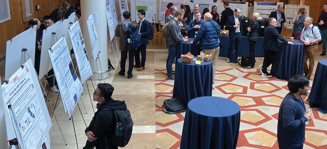 Room full of people who are presenting poster presentations.