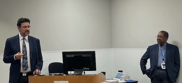 Two men standing on either side of a podium