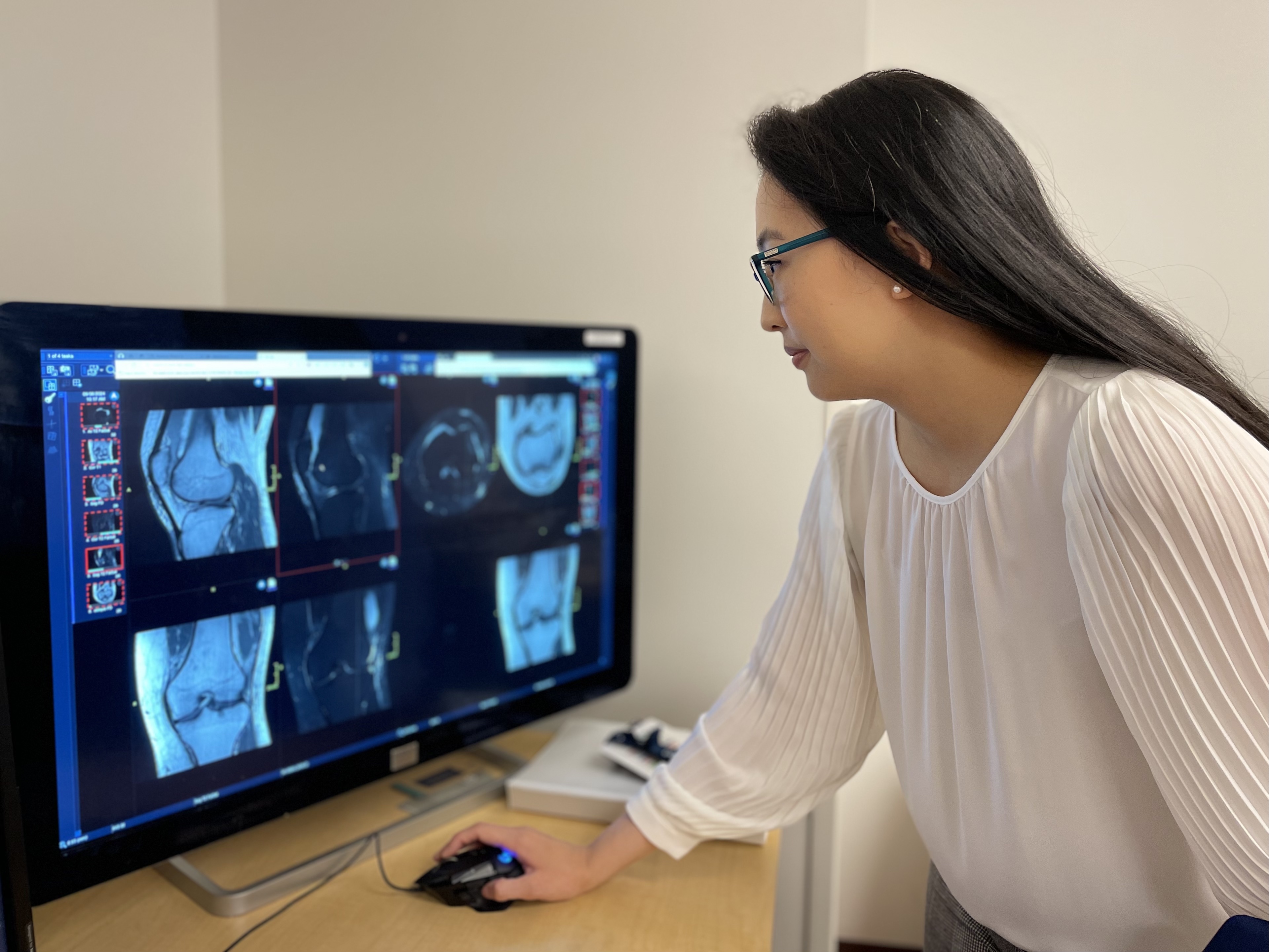 A woman looking at a computer screen.