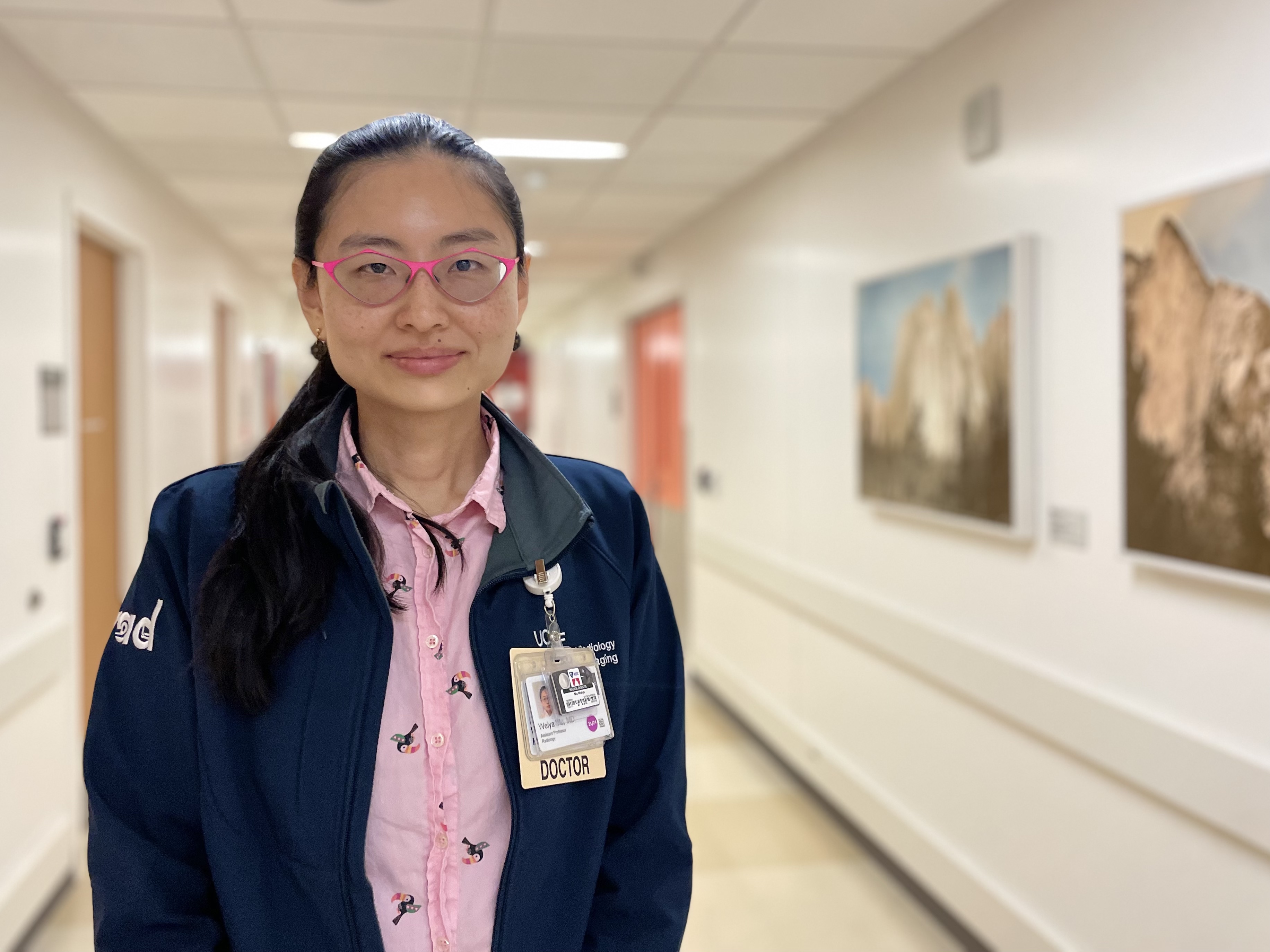 A woman smiling in the hallway at ZSFG.