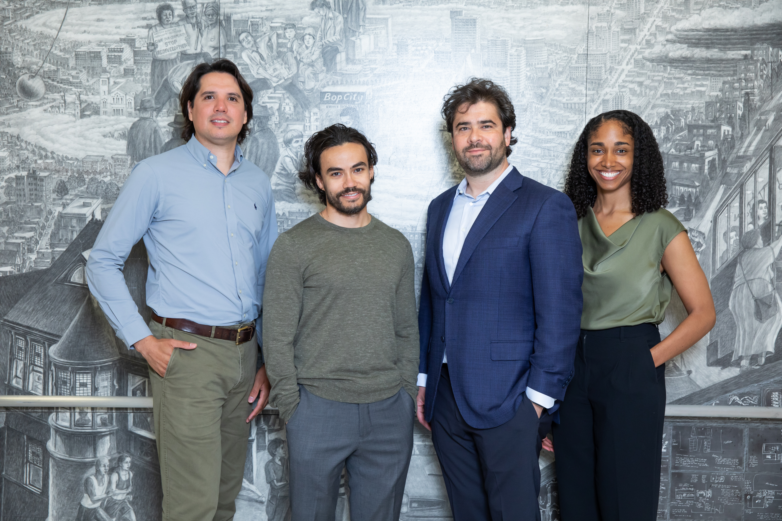 Group photo of the Neurointerventional Imaging Fellows standing in front of a grayscale mural.