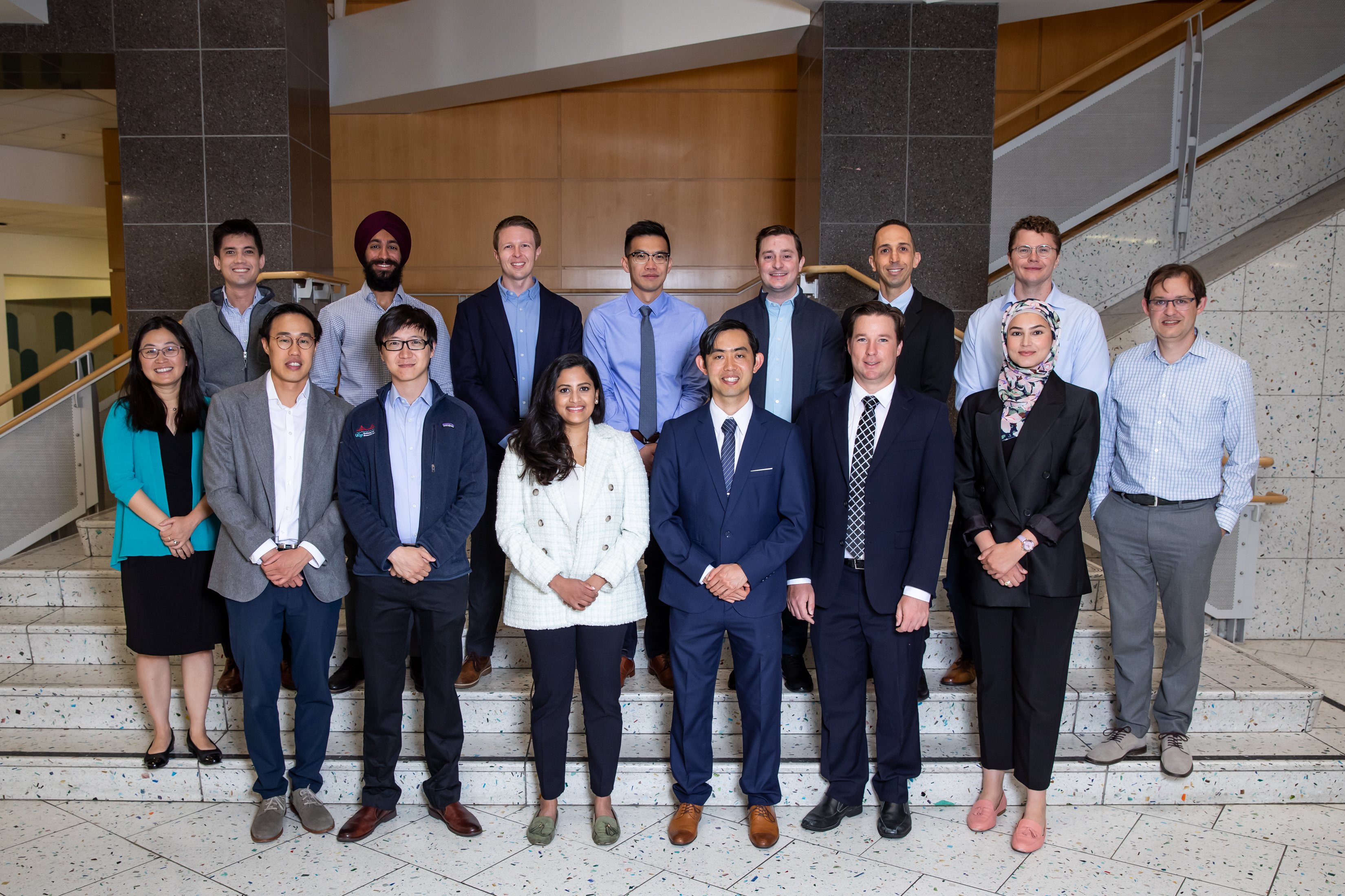 Group photo of the Neuroradiology Fellowship team standing on indoor steps.