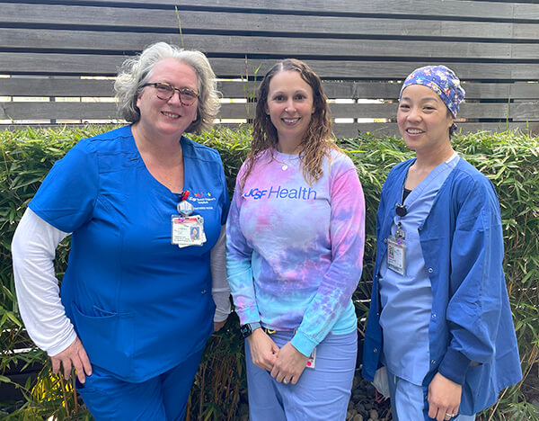 Three woman nurses posing for a picture.