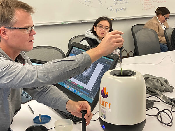 Peder Larson, PhD, demonstrates the tabletop MRI scanner to MSBI students